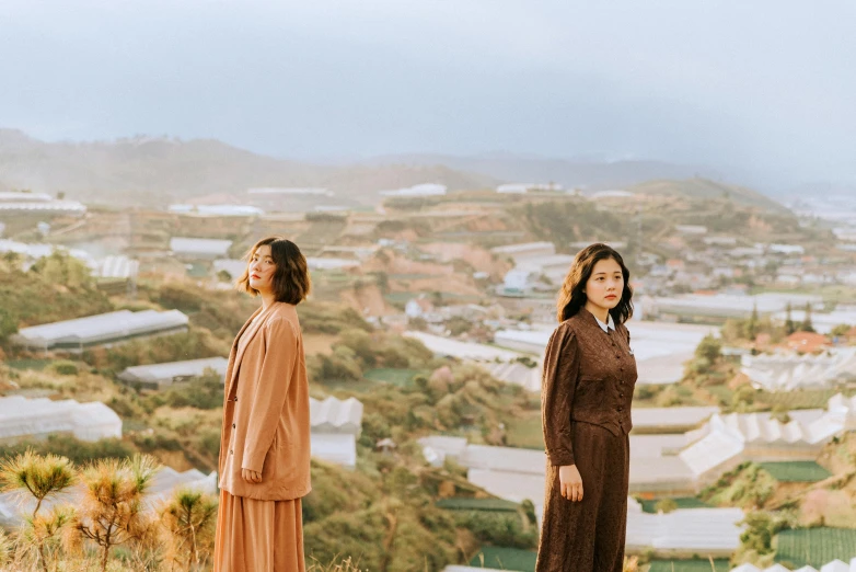 two women standing together looking over the city