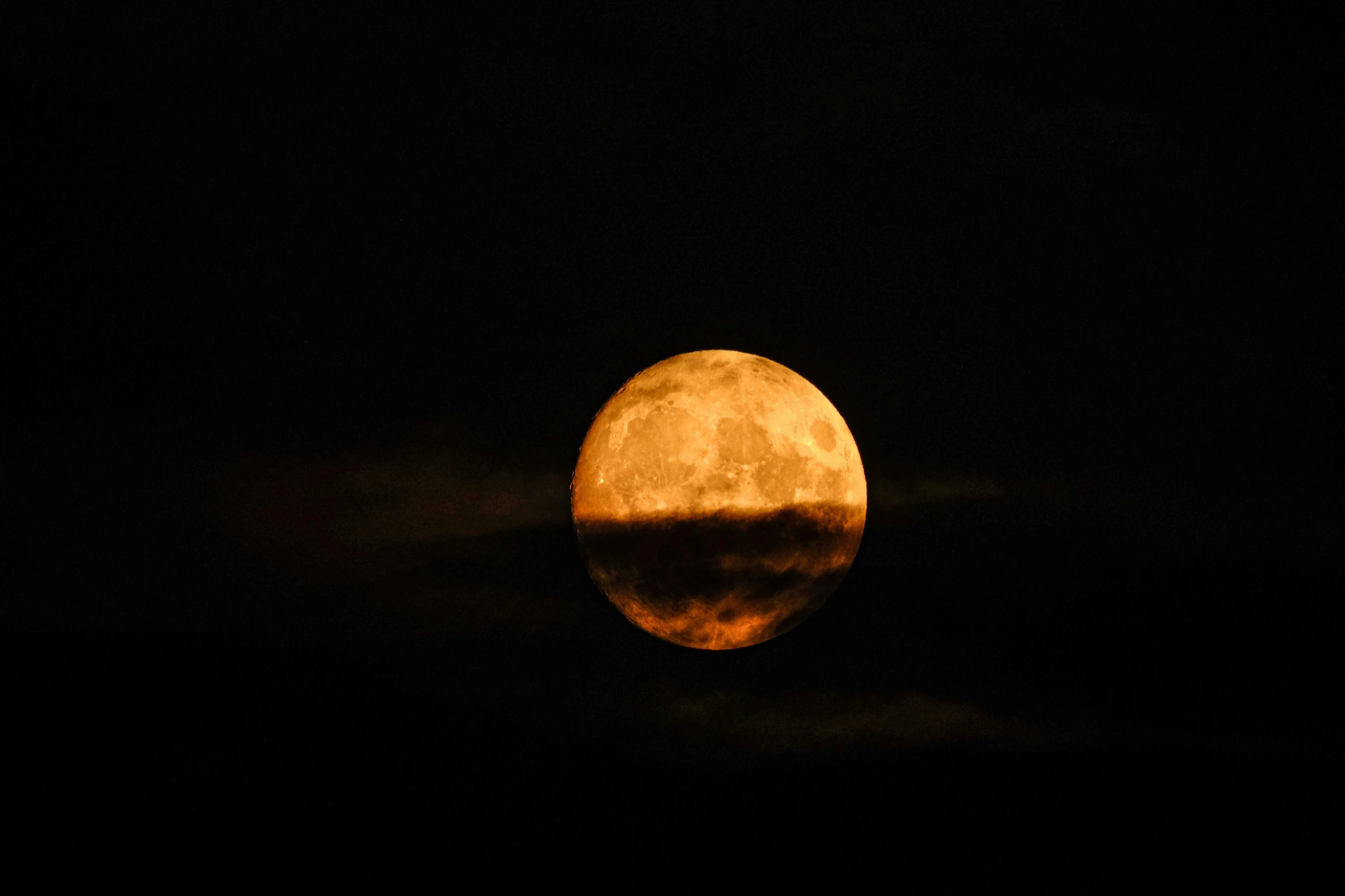 the full moon shining on the night sky