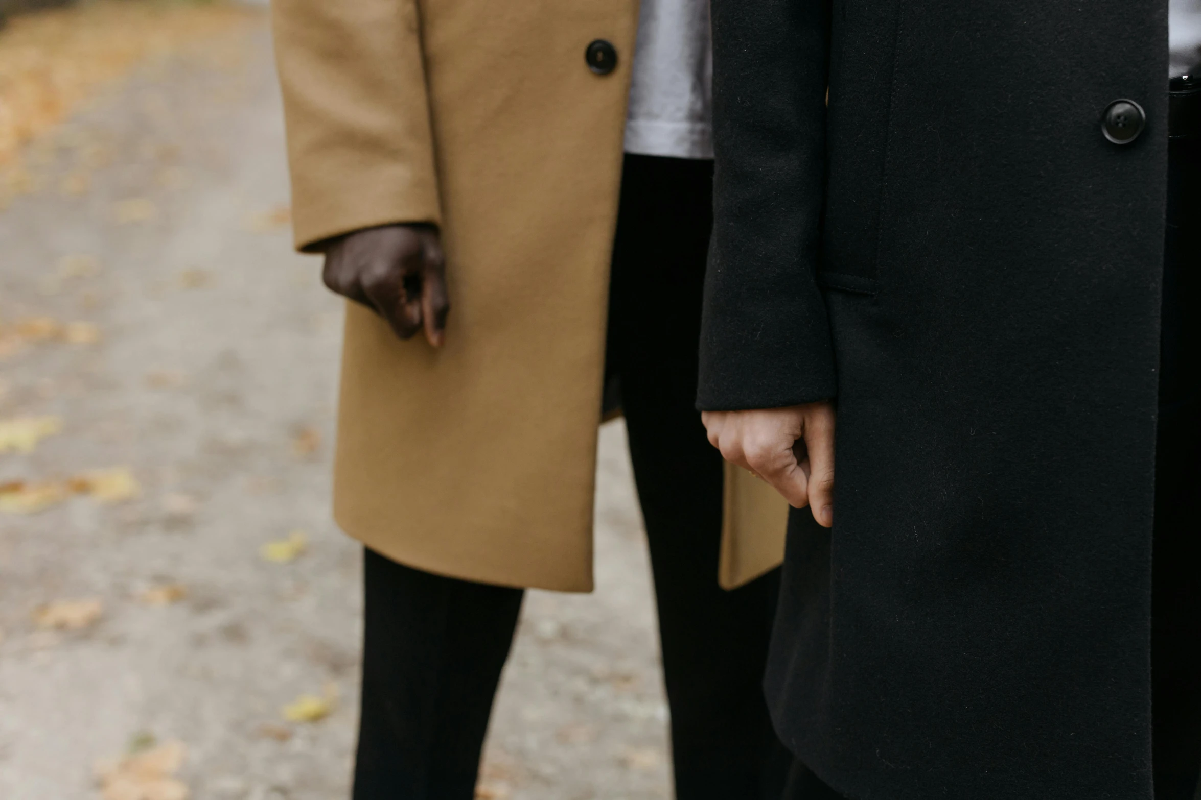 two people in coats walking next to each other