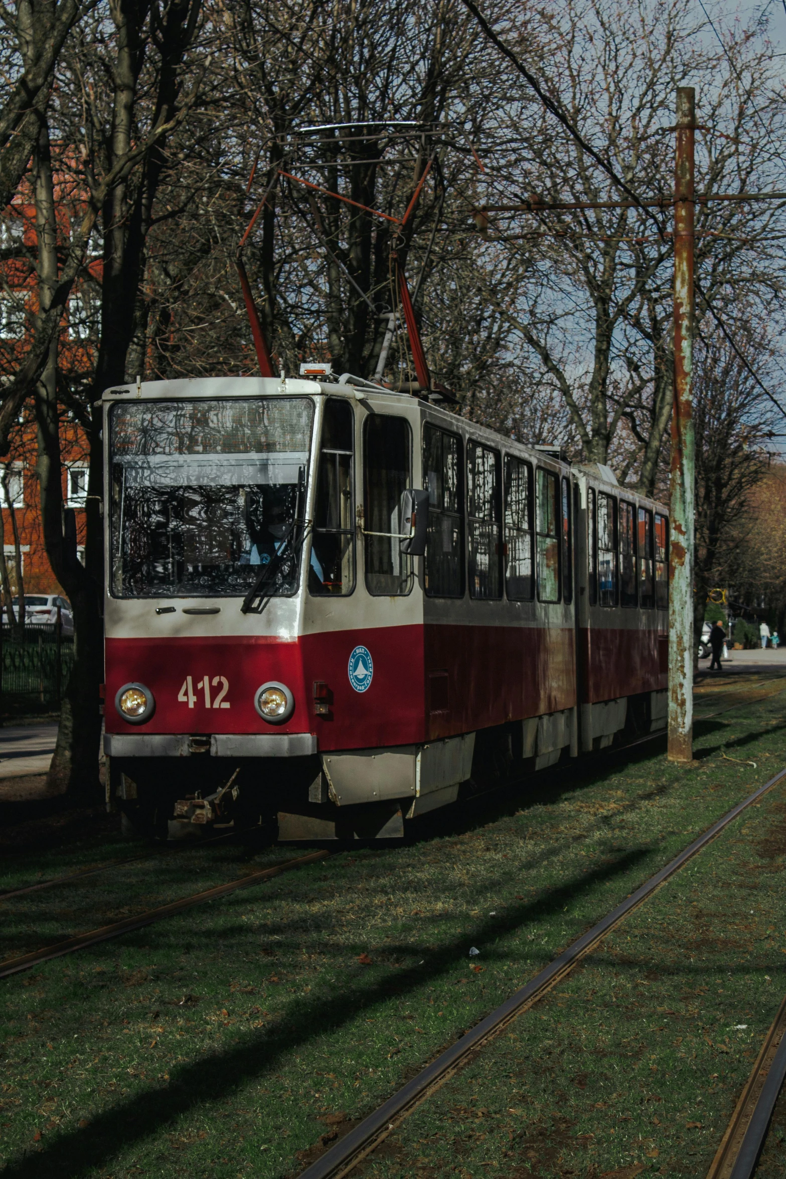 a red and white train parked on the tracks