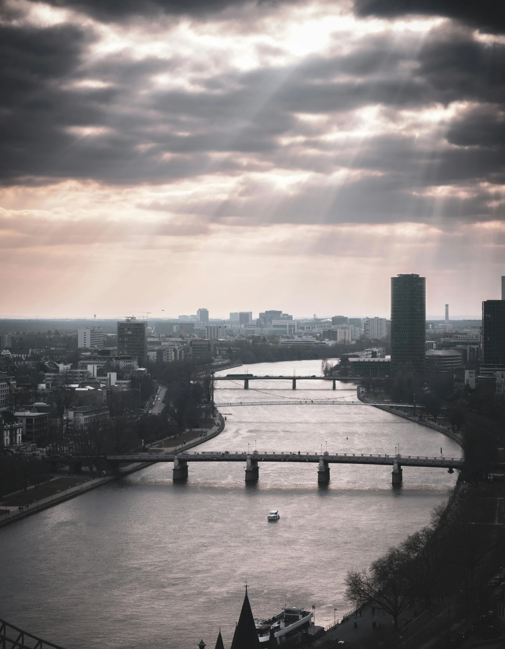 a large river flows through a city with tall buildings