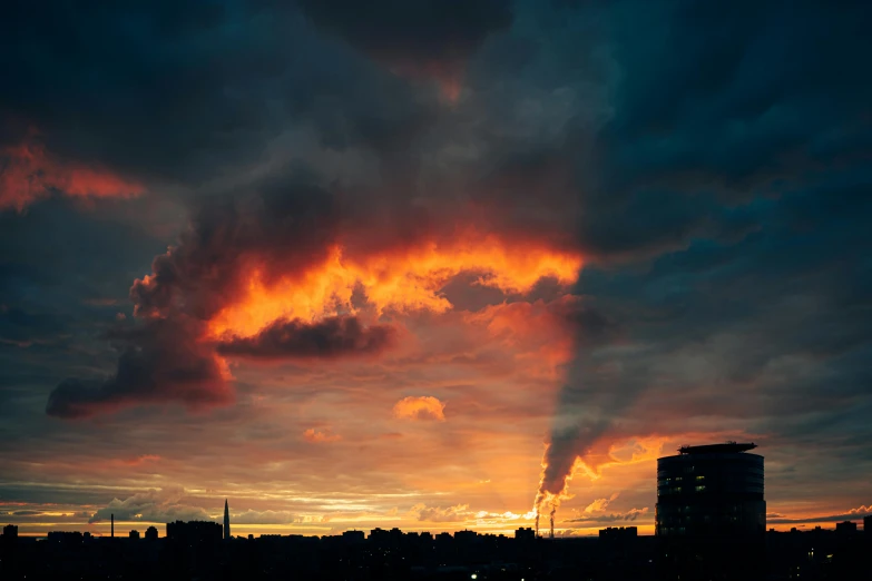 the clouds in the sky are very dark as sun sets