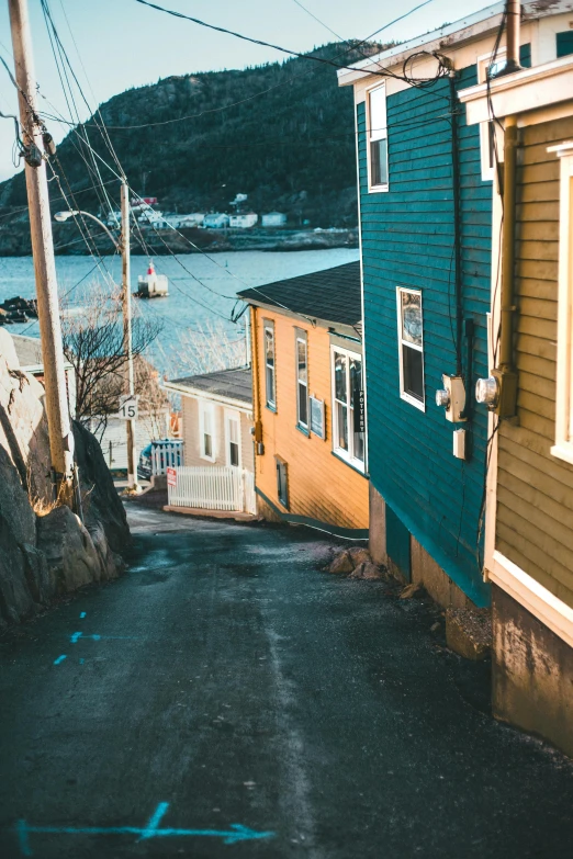 the blue and yellow buildings are by a body of water