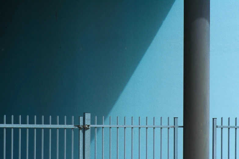 a metal fence against the side of a wall