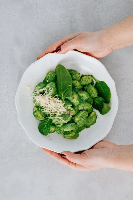 there is a white plate of vegetables on the table