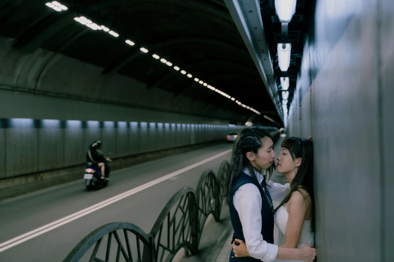 the man and woman are standing in front of a motorcycle