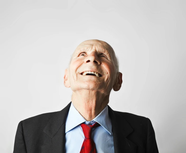 a man in a suit looking upward in the sky