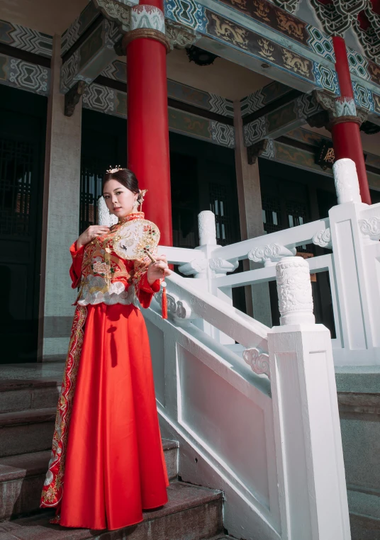 woman in a traditional chinese costume holding a fan