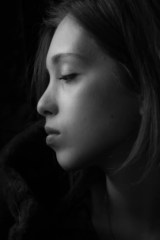 a woman's face and her hands resting on a chair