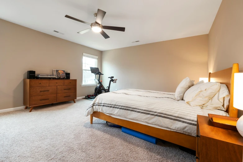 a bedroom with an unfinished ceiling and carpet