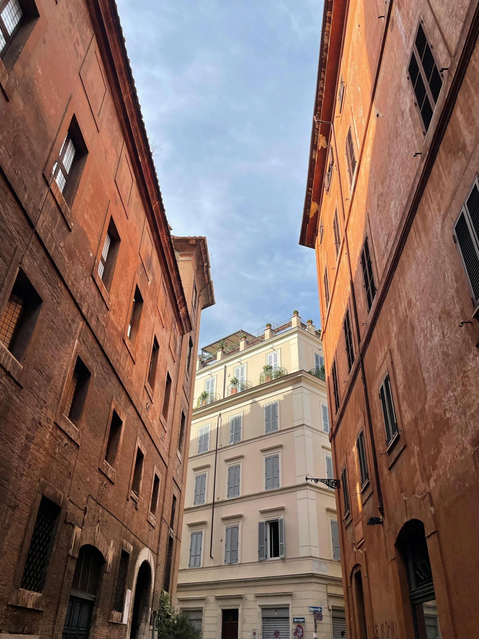 an alleyway with an old building between it and two others