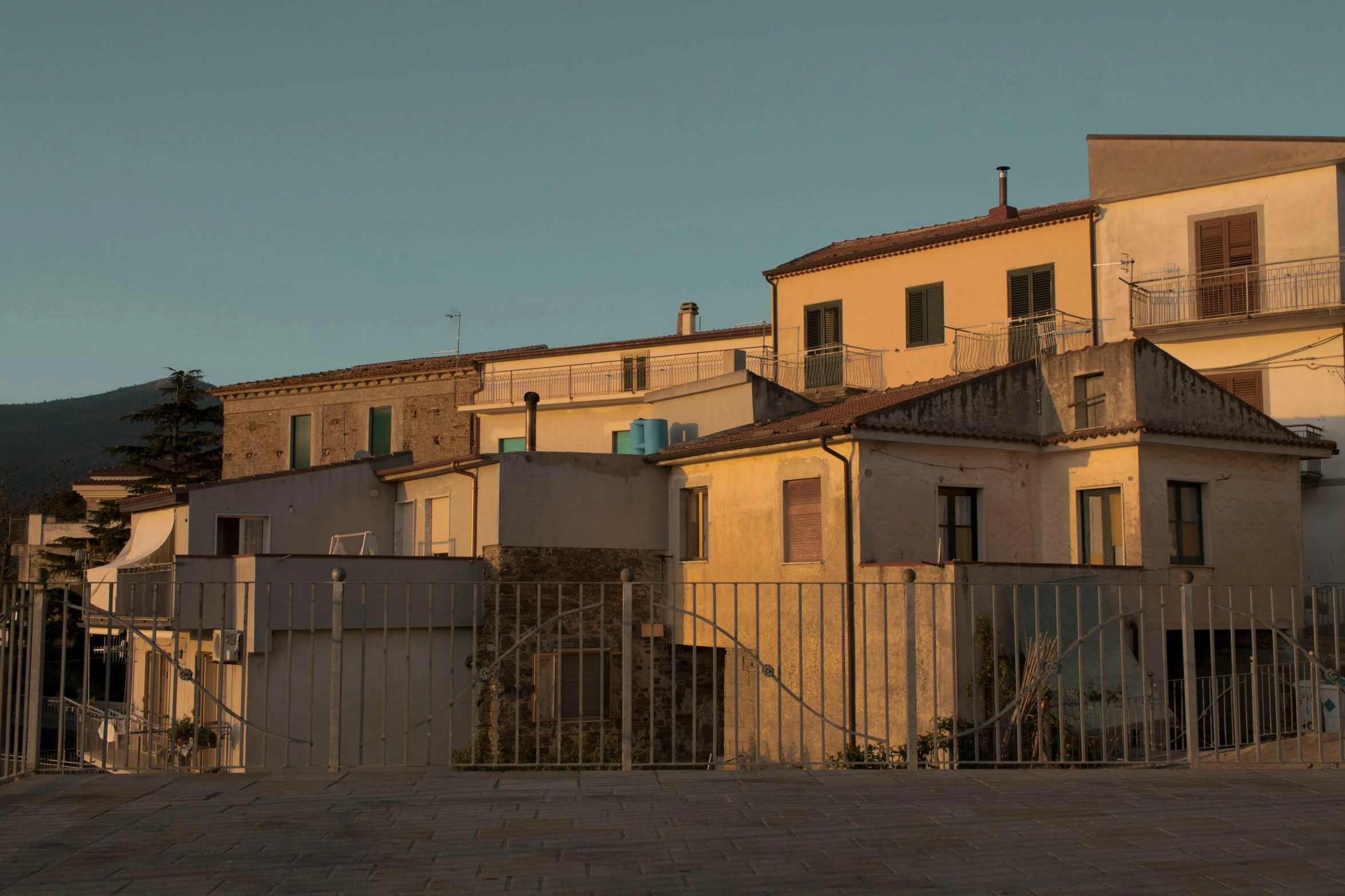 a bunch of old houses with a big gate in front