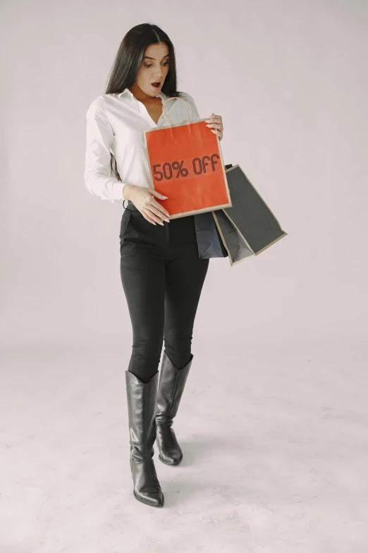 a woman holding a red book with writing on it