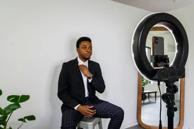 a man poses for the camera in front of a po studio