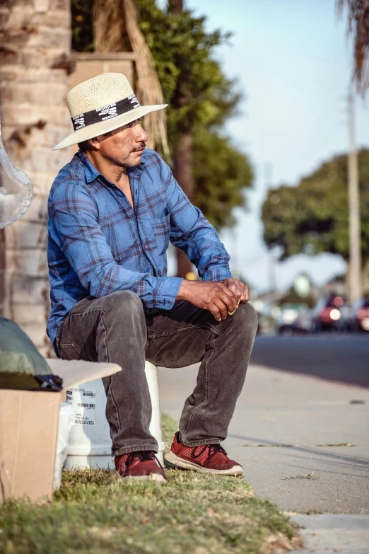 an older man sitting on a bench on the street