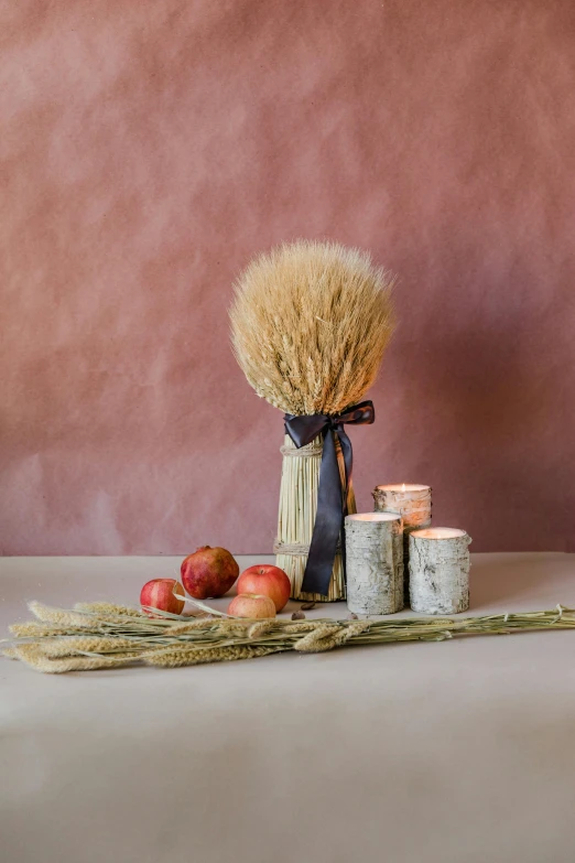 a wicker bundle sitting beside the candles, apples and cinnamon