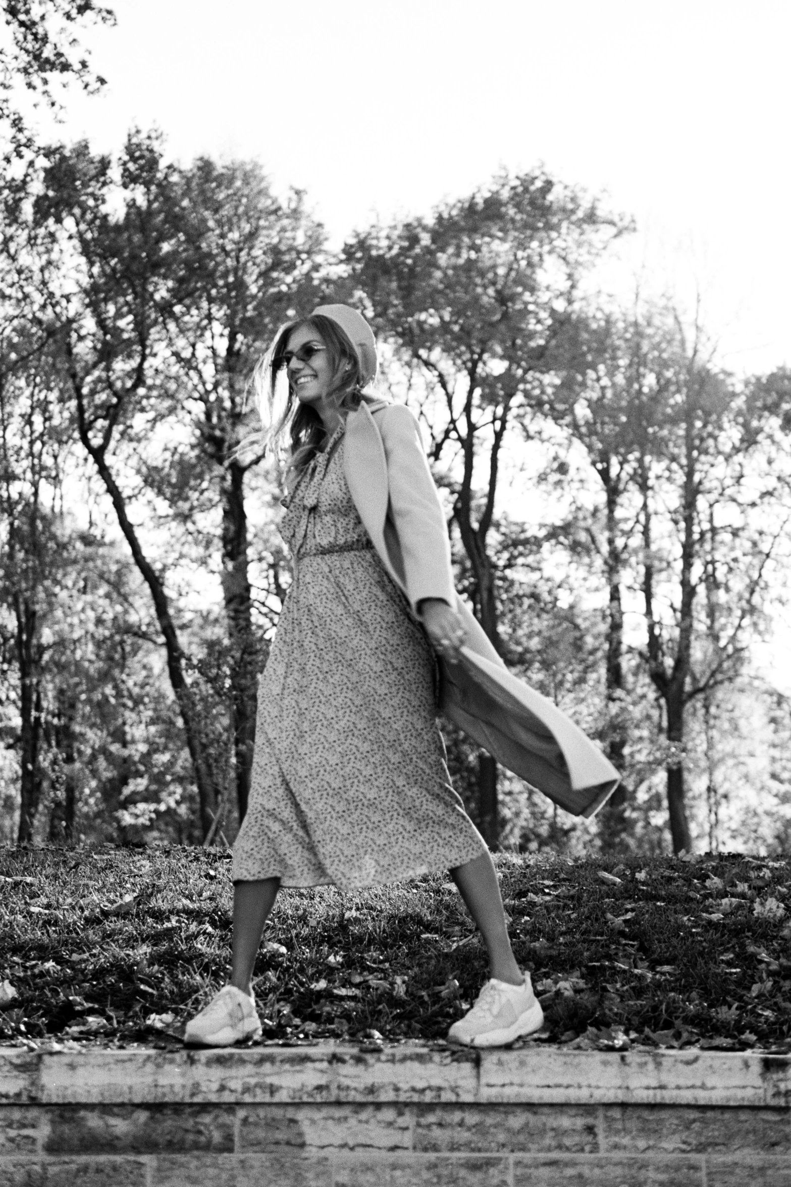 a black and white po of a woman walking in the rain