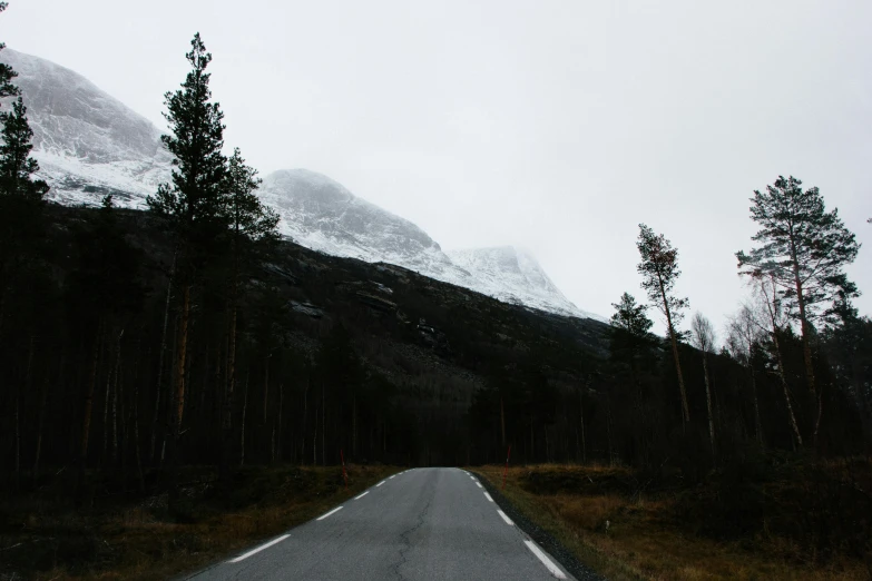 a mountain has a road in front of it