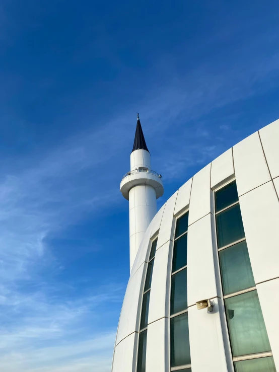 a very big pretty white building with a clock on top