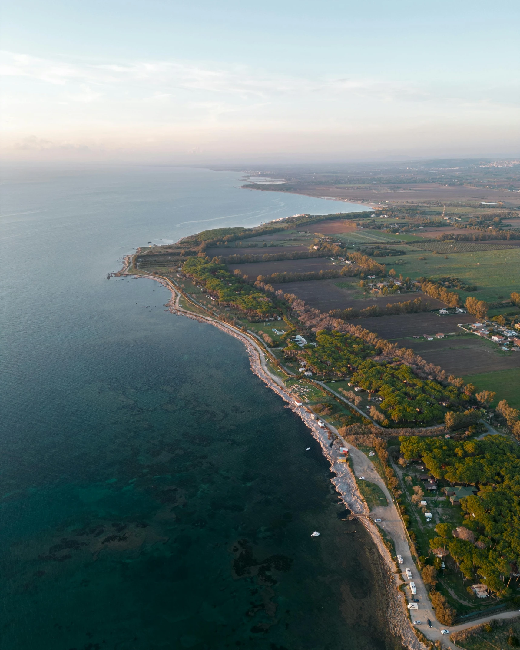 a bird's eye view of an island and road next to water