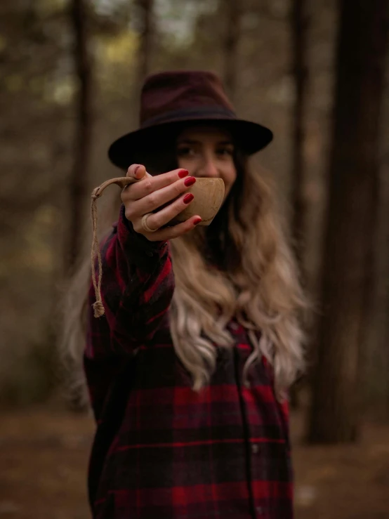 a woman wearing a hat with long blonde hair