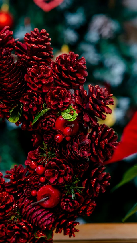 a red bouquet of flowers on a table