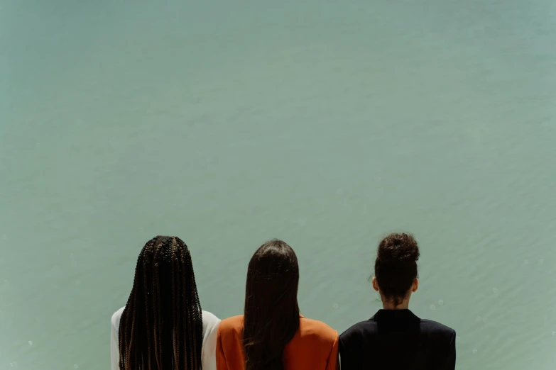 three people looking over the water at soing