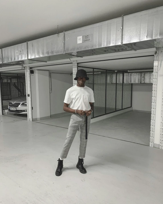 a man is standing in a parking garage