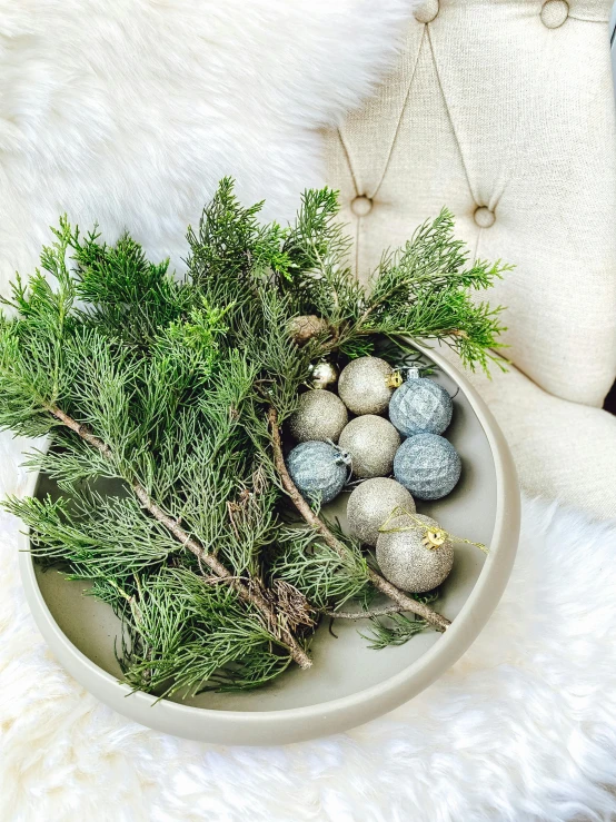 a basket full of christmas decoration on white fur