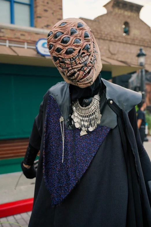 a statue in a black and purple outfit with many hair styles