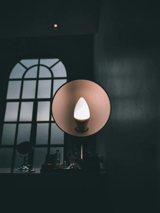 the lamp is on at the corner of a room