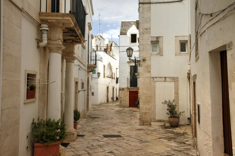 a street in the city filled with white buildings