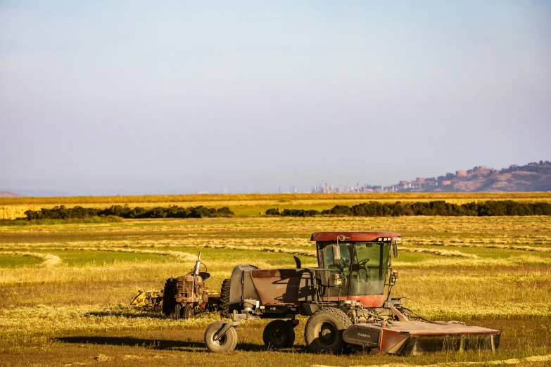 there is an old combine that has been harvested and is being guided through the field