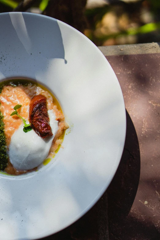 a plate topped with broccoli and fish on top of a white dish