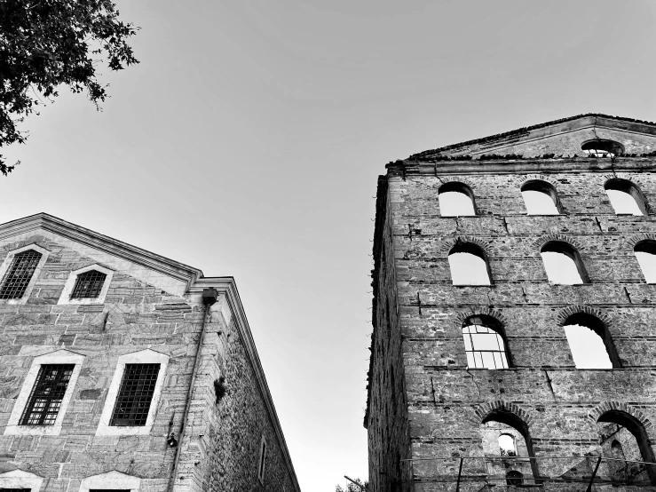 a couple of tall brick buildings with arched windows