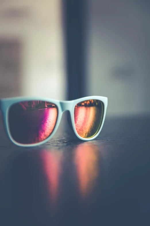 the reflection of two glasses that are on a table