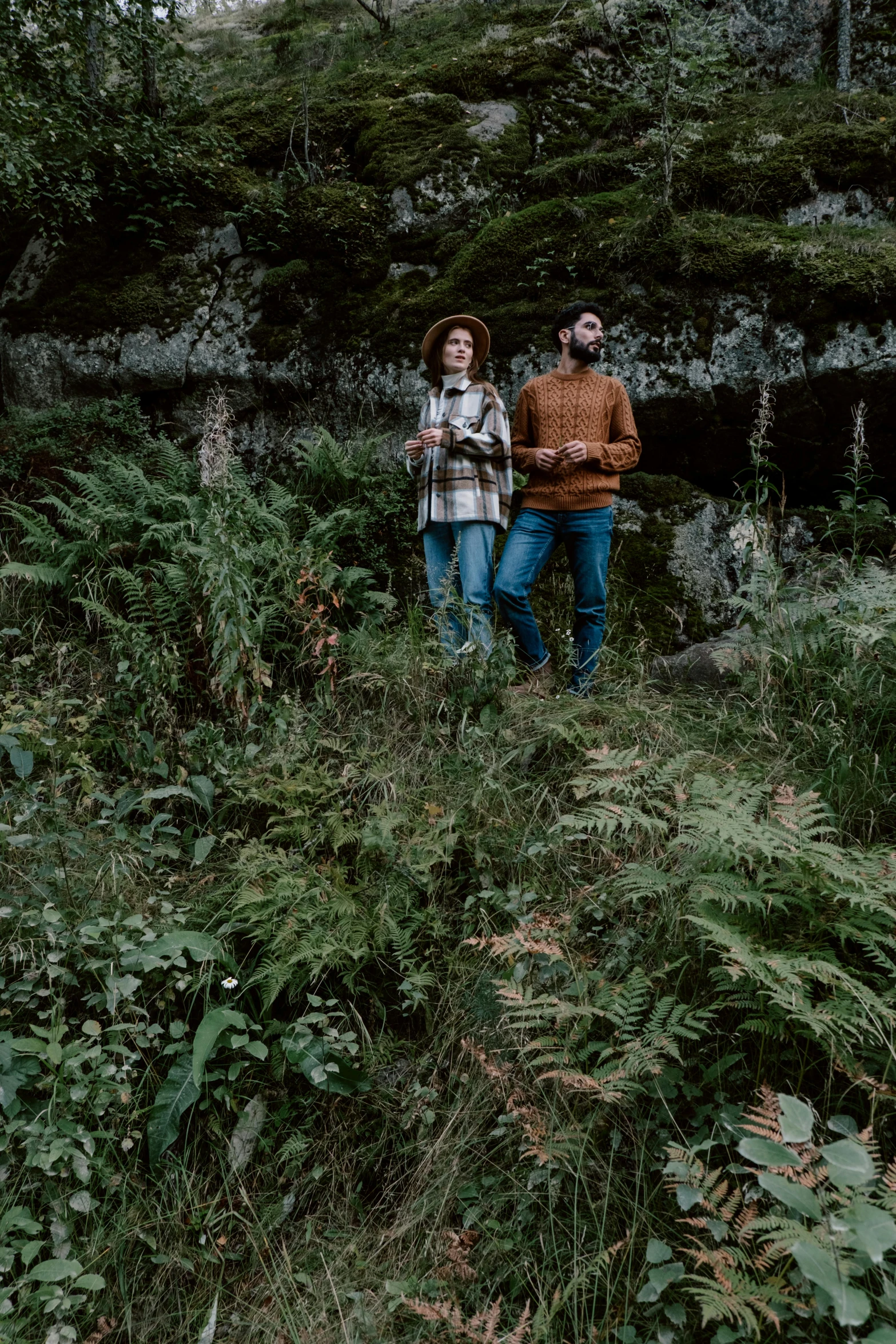 two people standing in tall grass near each other