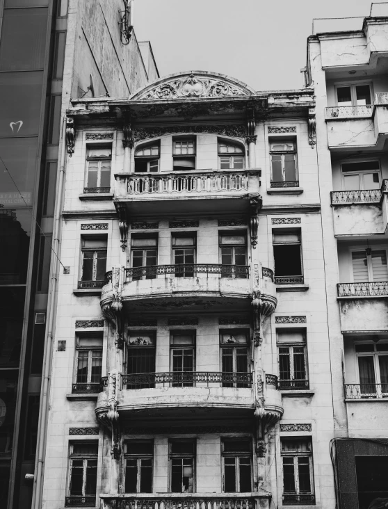 there is a building that has balconies on the windows