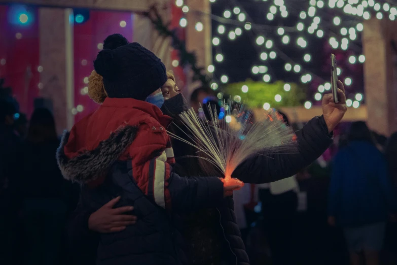 two people are holding up umbrellas at a festival