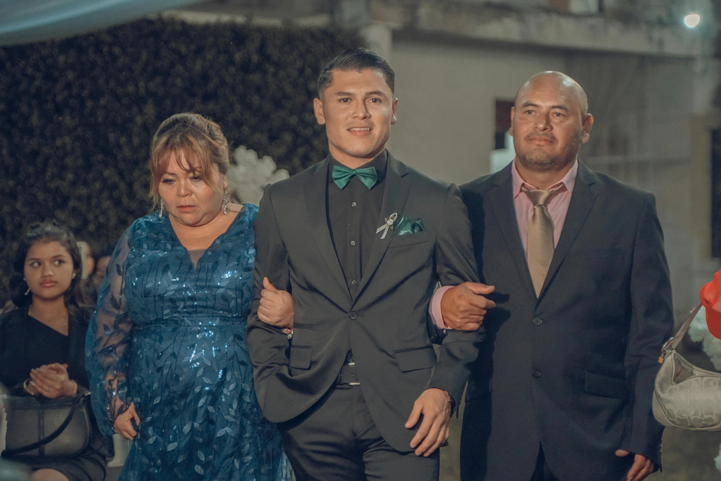 a man and a woman walk through the aisle at a wedding