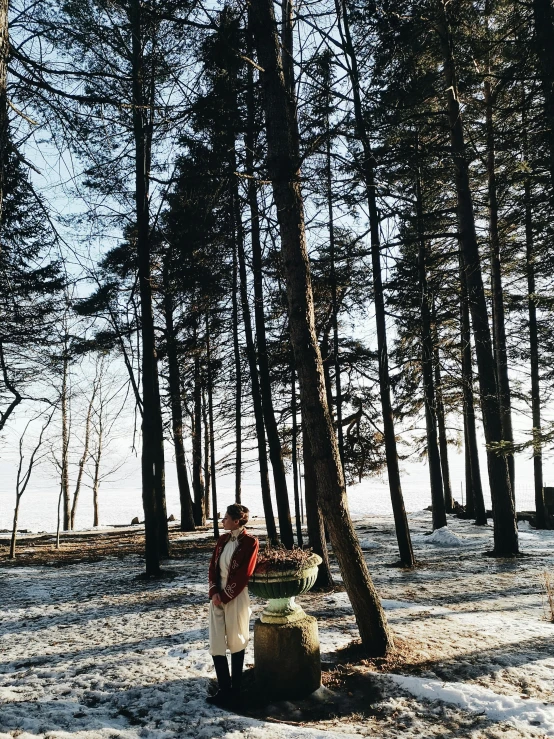 a person standing in front of some trees