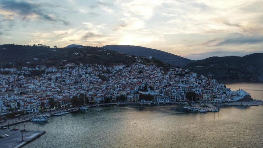 a river filled with boats sitting next to a hillside