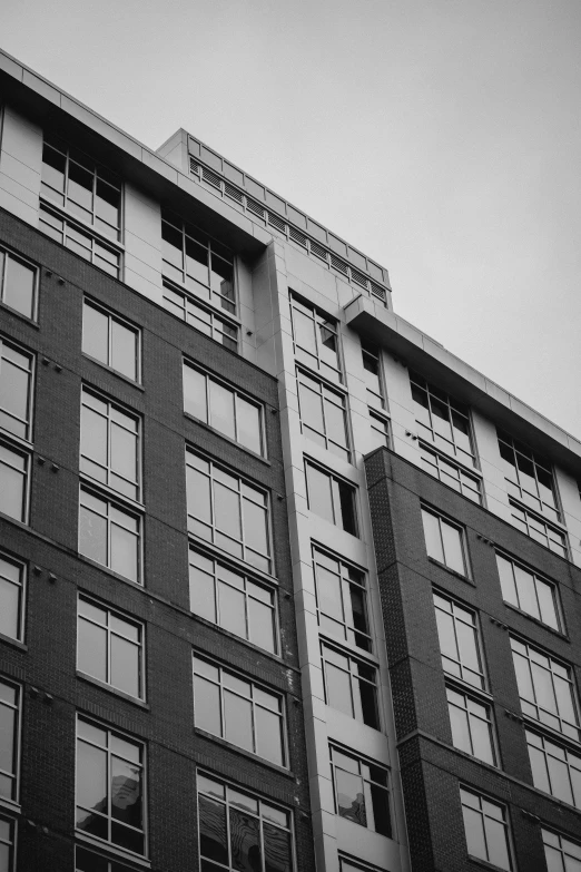 an office building with lots of windows and a clock on the side