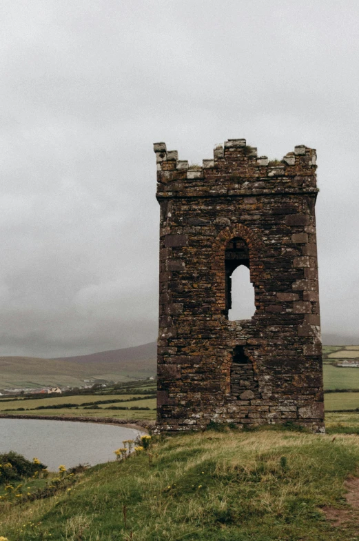 an old tower on the top of a hill