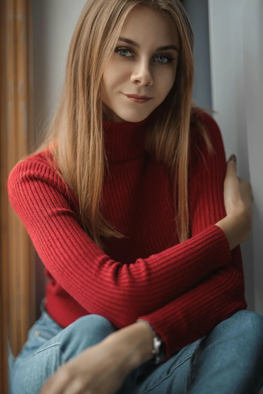 young lady in red sweater looking into the camera