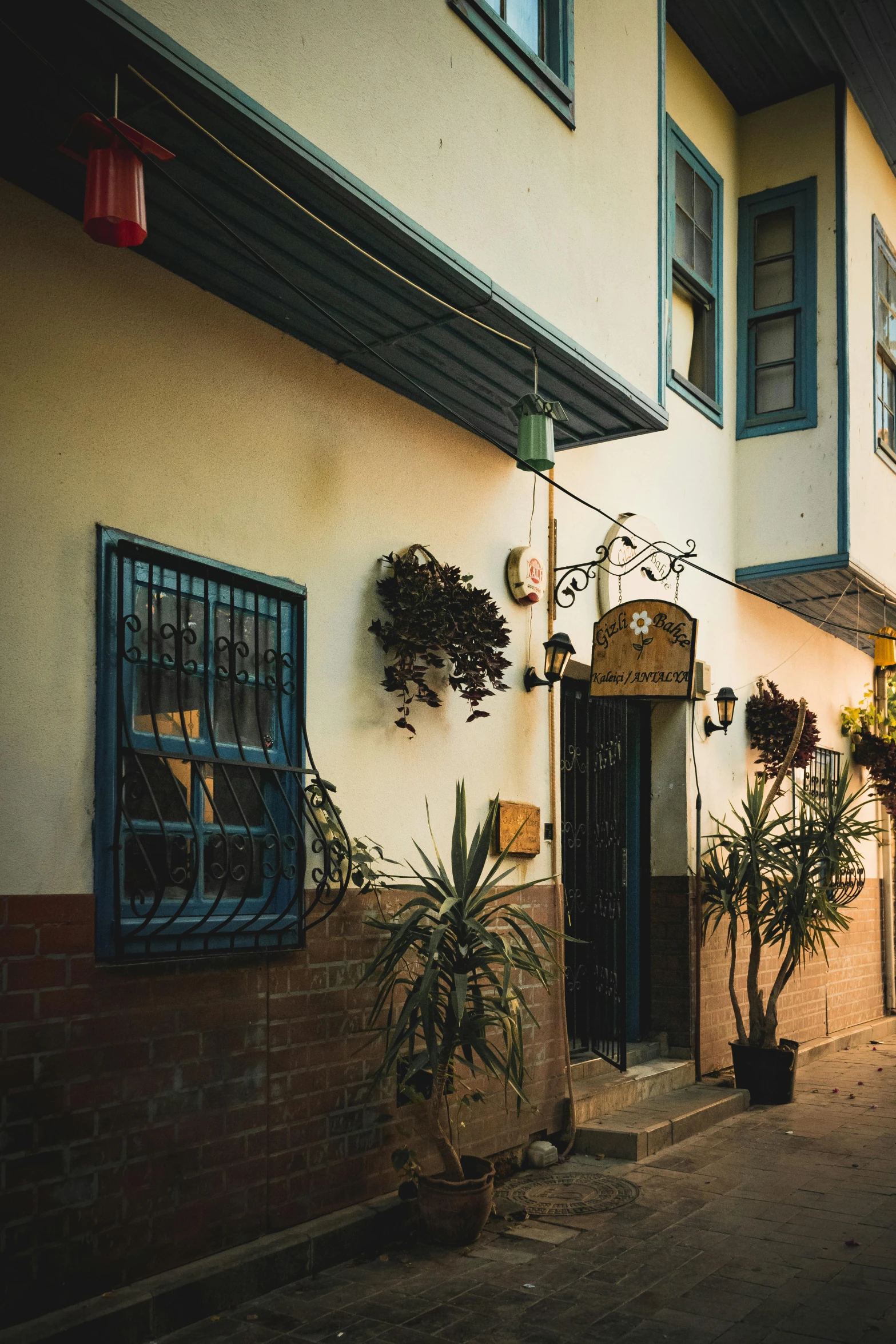 a brick and stucco building with a planter on it's left side