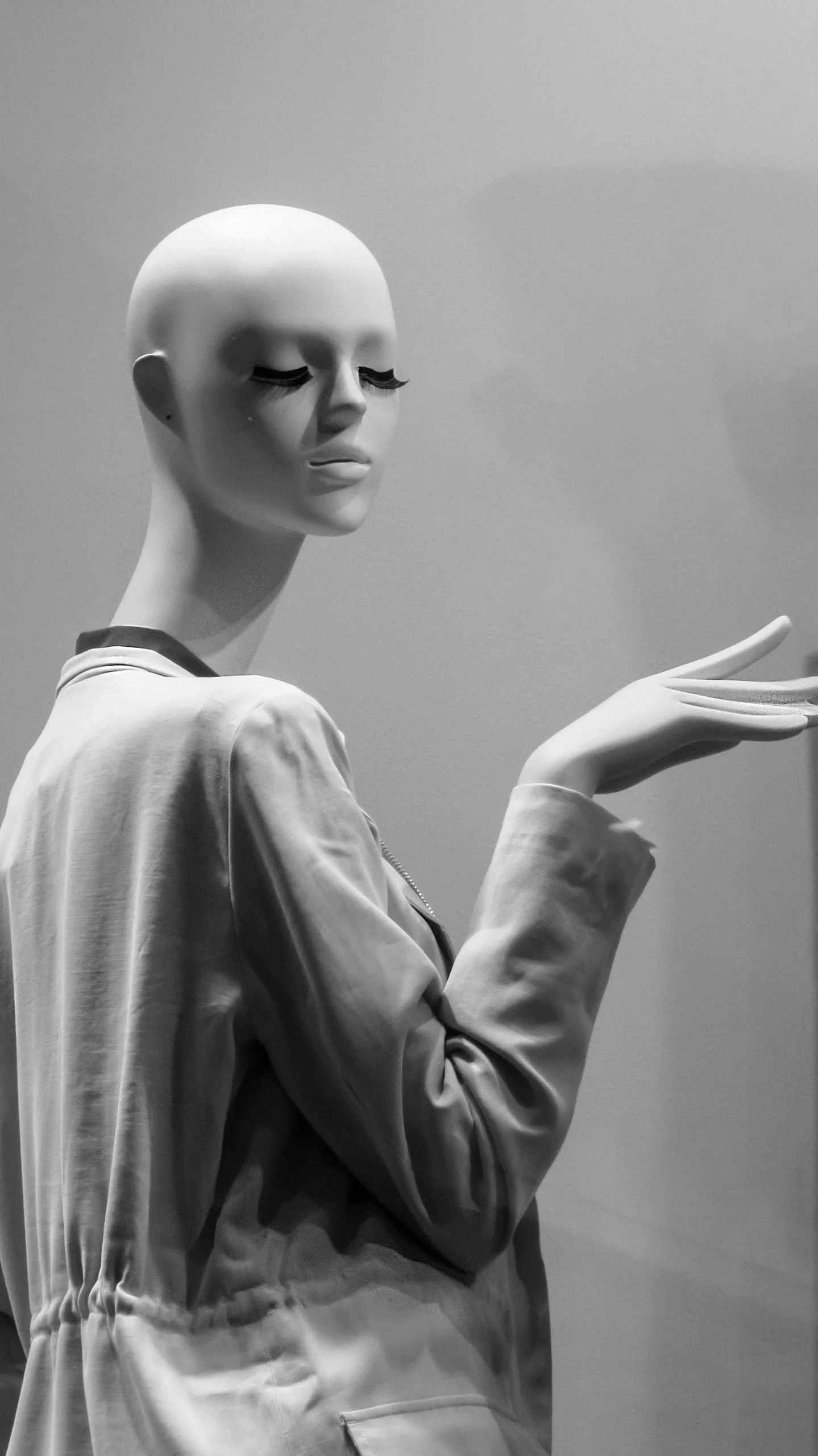 black and white image of mannequins with closed arms