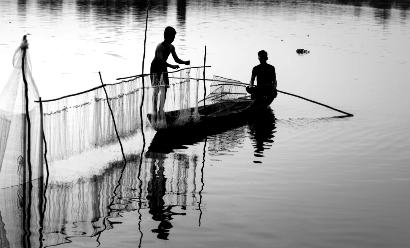 two people stand on a boat and look at the camera