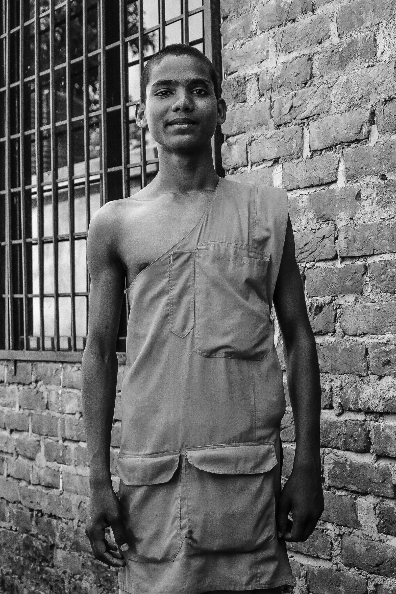 a man standing in front of a brick building