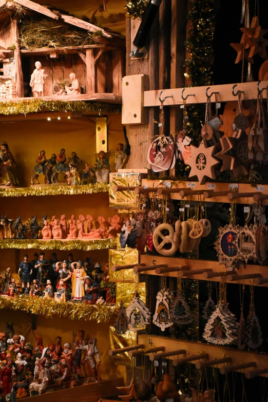 a wooden shelf with a variety of holiday figurines displayed in it